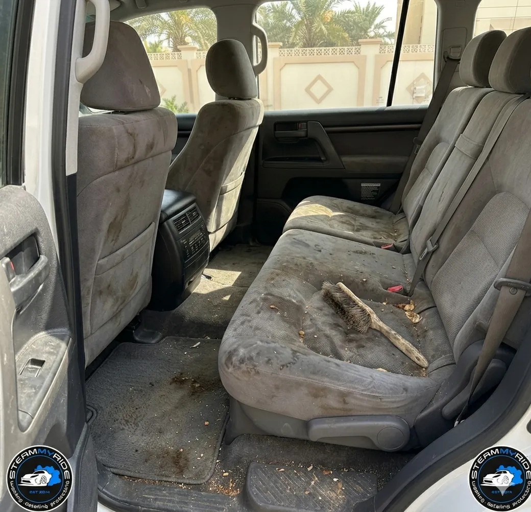 Stained, dusty rear seats before interior deep cleaning